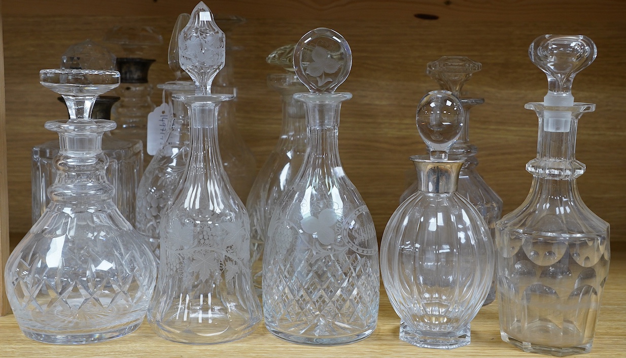Thirteen Victorian and later glass decanters including three silver mounted examples, tallest 30cm high. Condition - varies, mostly fair